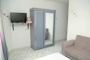 a living room with a glass cabinet and a television at Golf paradis in Oran