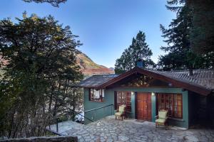 a small house with two chairs in front of it at Rancho del Lago in San Carlos de Bariloche
