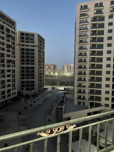 a view of two tall buildings in a city at Golf paradis in Oran