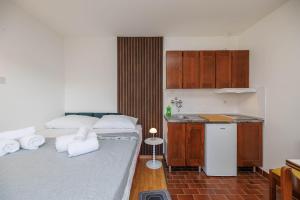 two beds in a small room with a kitchen at Maja Apartments Malinska in Malinska
