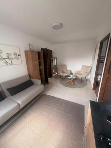 a living room with a couch and a table and chairs at Casa do camiño in Villariño