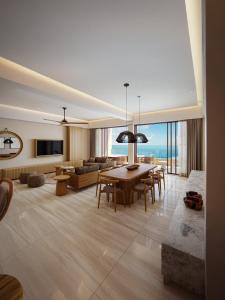 a large living room with a table and a couch at Inna Resort & Spa in Puerto Morelos