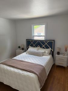 a bedroom with a large bed and a window at Boho room in house in New Haven +2 photos