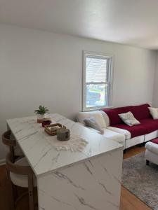 a living room with a white counter top and a couch at Boho room in house in New Haven