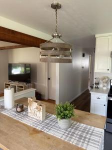 a kitchen with a table and a chandelier at Boho room in house in New Haven