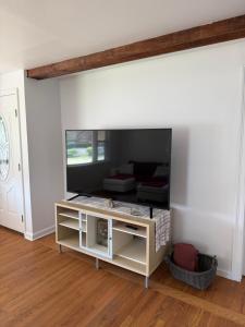 a living room with a large mirror on the wall at Boho room in house in New Haven