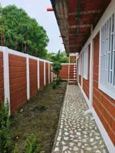 a hallway of a house with a brick wall at Cabaña los villa in Necoclí