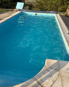 a swimming pool with blue water at Cuchac Cuchic in Las Compuertas