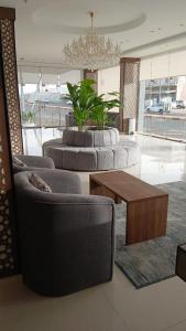 a living room with couches and a coffee table at علي ريزيدنس Ali Residence in Khamis Mushayt
