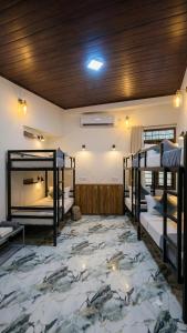 a room with three bunk beds and a carpet at Ceylora Resort in Sigiriya