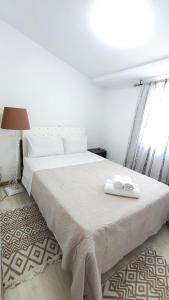 a bedroom with a white bed with two towels on it at Villa Aura, Kanalia Corfu in Corfu +37 photos