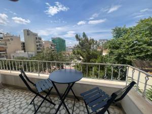 a table and two chairs on a balcony at Sfiggos 54 Guest House in Athens