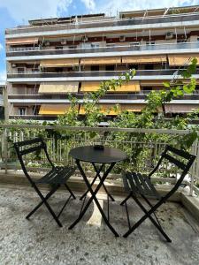 a table and two chairs next to a table and a building at Sfiggos 54 Guest House in Athens +22 photos