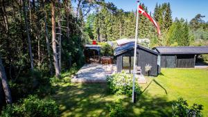 a gazebo in a yard with a flag at Holiday house close to nature in Glesborg