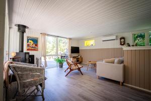 a living room with a couch and a table at Holiday house close to nature in Glesborg