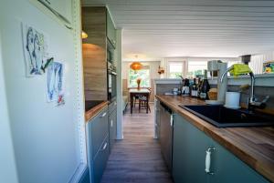 a kitchen with blue cabinets and a counter top at Holiday house close to nature in Glesborg