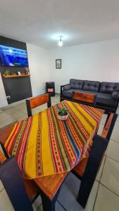 a dining room table with a colorful blanket on it at Dúplex céntrico LAS SOFIAS - PURMAMARCA in Purmamarca