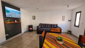 a living room with a couch and a bed at Dúplex céntrico LAS SOFIAS - PURMAMARCA in Purmamarca