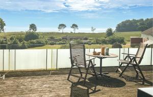 a table and chairs on a patio with a view at Amazing Home In Augustenborg With Sauna in Augustenborg