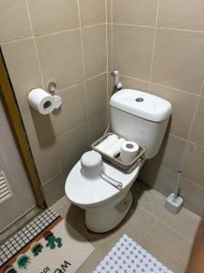 a bathroom with a toilet and two rolls of toilet paper at DASIG Homes1 near airport, Bayanihan Flats 1 Condominium Mactan in Pajak +35 photos