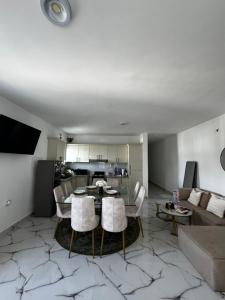 a living room with a table and a couch at Apartamentos SCARLEM in Higuey