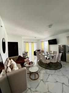 a living room with a couch and chairs and a table at Apartamentos SCARLEM in Higuey