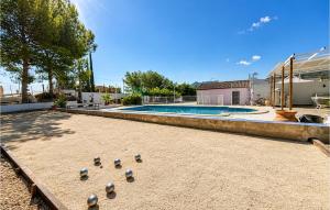 a group of balls on the ground near a swimming pool at Awesome Home In Abarán in Abarán +14 photos