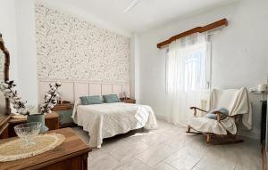 a bedroom with a bed and a table and a window at Awesome Home In Abarán in Abarán