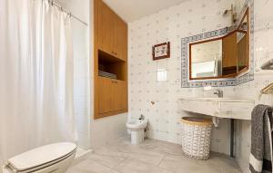 a bathroom with a toilet and a sink and a mirror at Awesome Home In Abarán in Abarán