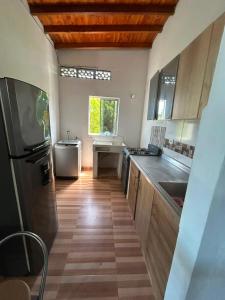 a kitchen with a sink and a refrigerator at Villa Magdalena y Puerto Perales in La Piedad