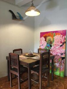 a dining room table with chairs and a painting on the wall at Beachside House with 2 bedrooms in Dalumpinas Oeste +38 photos