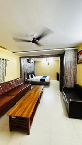 a living room with a couch and a bed at Hotel Raj Palace in Āzamgarh