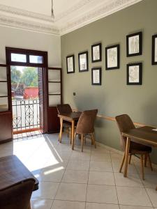 a dining room with tables and chairs and a window at TANJALUCIA HOSTeL in Tangier