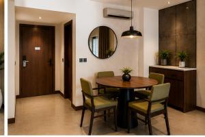 a dining room with a table and chairs and a mirror at Bosque Hotel in Hurghada
