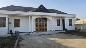a white house with a large glass door at Abusera Bishoftu Guest House in Yerer