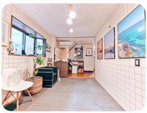 a room with white tile walls and windows at NEXTRAVELER iNN in Osaka