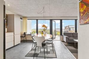 a kitchen and dining room with a table and chairs at G213-Lemvig-Skovstjernevej-13 in Lemvig