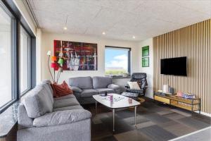 a living room with a couch and a table at G213-Lemvig-Skovstjernevej-13 in Lemvig