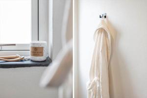 a towel hanging on a door next to a window at G213-Lemvig-Skovstjernevej-13 in Lemvig +29 photos