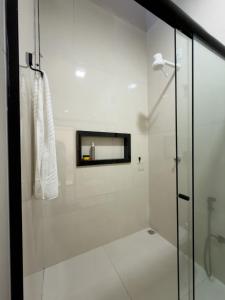 a bathroom with a shower with a glass door at Casa 01 - Completa e moderna 5 minutos do centro in Alta Floresta +22 photos