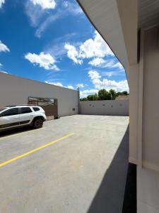a white car parked in a parking lot at Casa 01 - Completa e moderna 5 minutos do centro in Alta Floresta