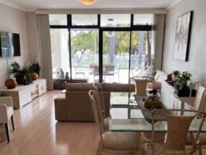 a living room with a table and a couch at Seaside Escape Rockingham in Rockingham +5 photos