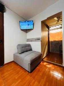 a living room with a couch and a flat screen tv at Hospedaje el Trujillanito in Víctor Larco Herrera
