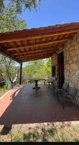 a pavilion with a picnic table and benches on a patio at Cabaña Camping Cabalango in Cavalango