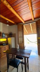 a wooden table and chairs in a kitchen with a table and a table at Cabaña Camping Cabalango in Cavalango