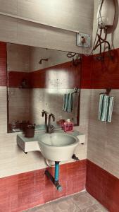 a bathroom with a sink and a mirror at Nasik Homestay in Nashik +39 photos