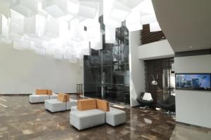 a lobby with white furniture and a large chandelier at Holiday Inn Express San Luis Potosí by IHG in San Luis Potosí
