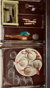 a microwave with a plate and other kitchen utensils at Nasik Homestay in Nashik