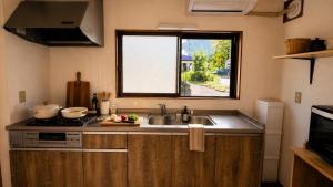 a kitchen with a sink and a window at IWAKI Stay KAKUREGI in Hirosaki