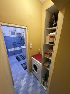 a bathroom with a washing machine in a room at Old Town view apartment in Bar